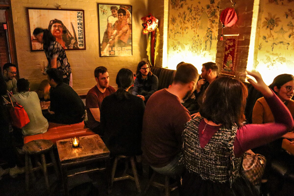 Meetup members attending the DesignOps meetup at Double Happiness bar, sitting down and talking
