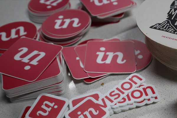 Table full of InVision stickers and merch