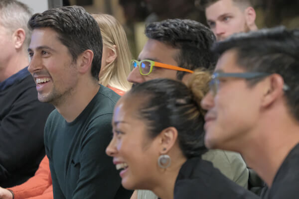 Members of the DesignOps meetup laughing in their seats