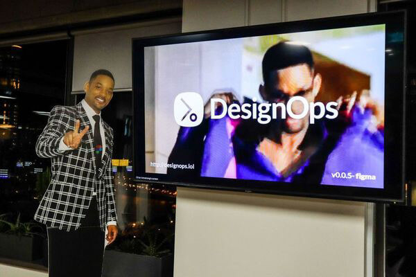 Cardboard cutout of Will Smith standing next to a TV with an image of Will Smith